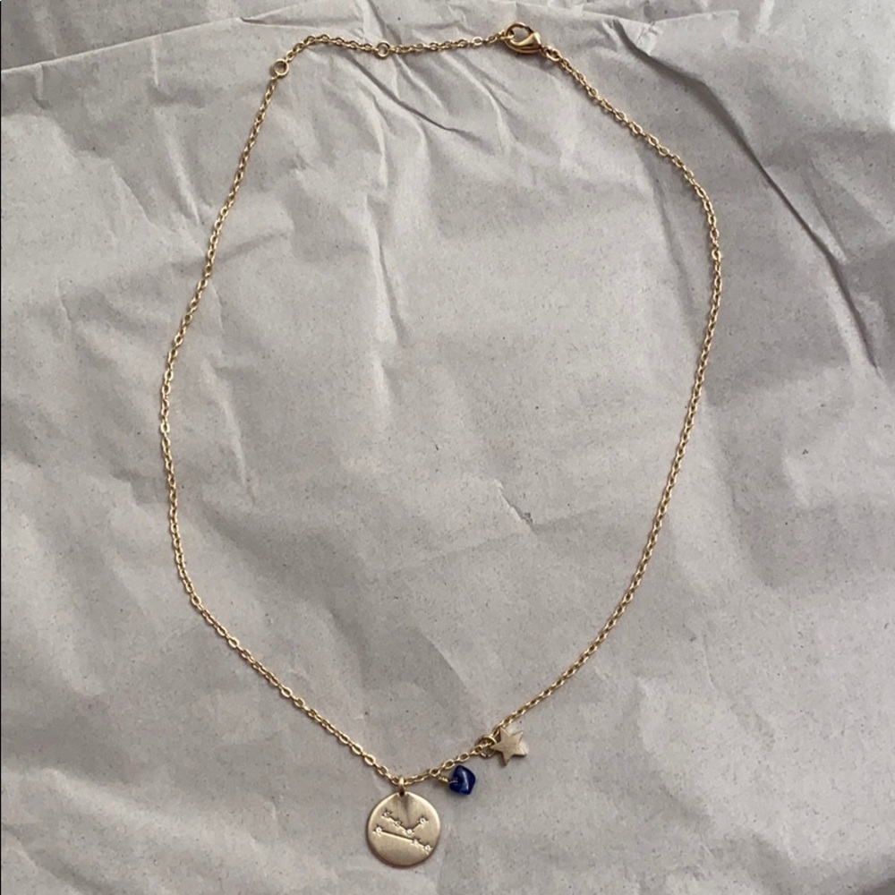 Gold tone Taurus symbol necklace